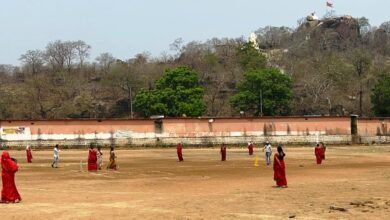 Women play cricket and call for 100 percent voting in district.