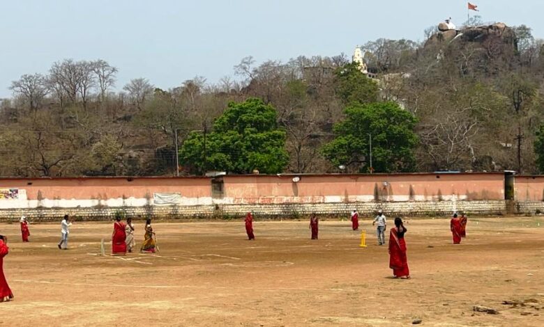 Women play cricket and call for 100 percent voting in district.