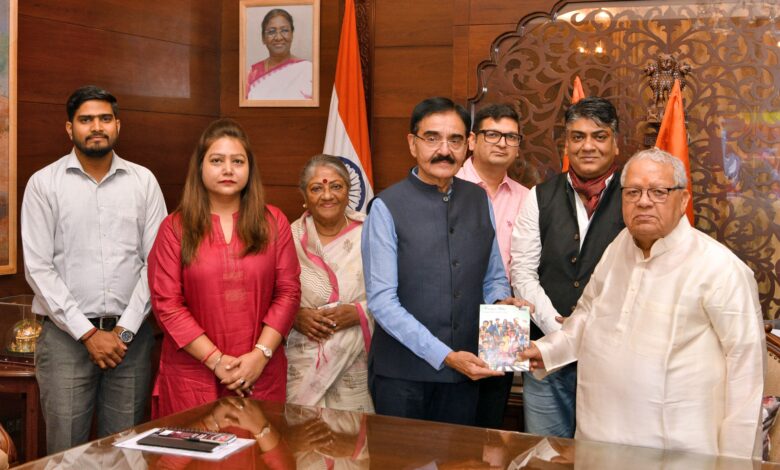 Governor presents copy of graphic novel on road safety.